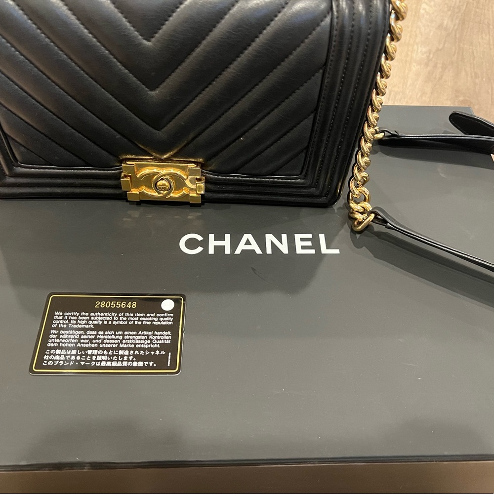 Black leather and gold Chanel purse. slight blemish on back right corner